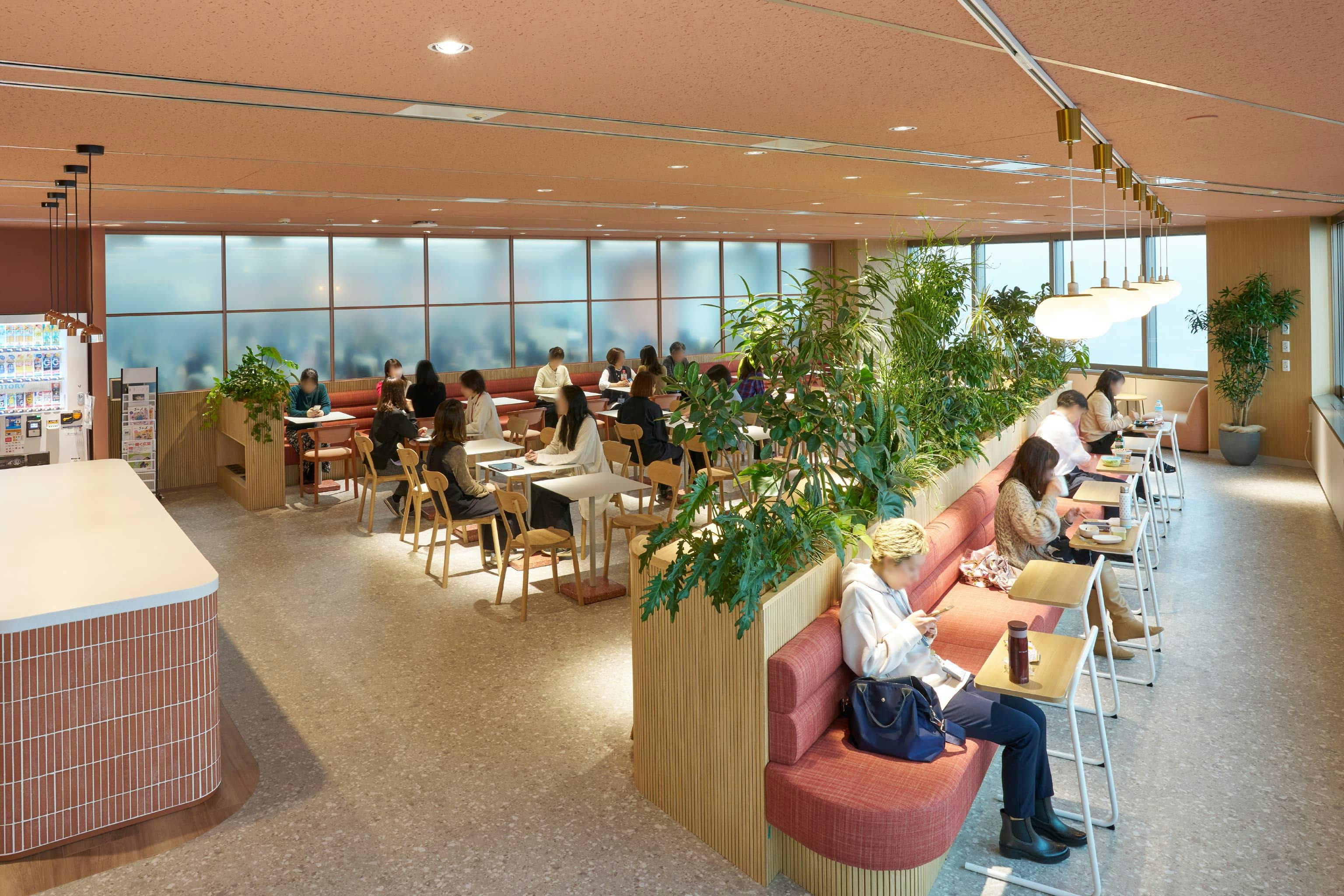 株式会社JALナビア 様の事例写真／[Chill Café]気持ちのオンオフを切り替えられるよう、執務エリアとは間仕切りで区切られています。複数人で会話を楽しむ人もいれば、一人で静かに過ごす人もいて、それぞれ自由なスタイルでリフレッシュしています。