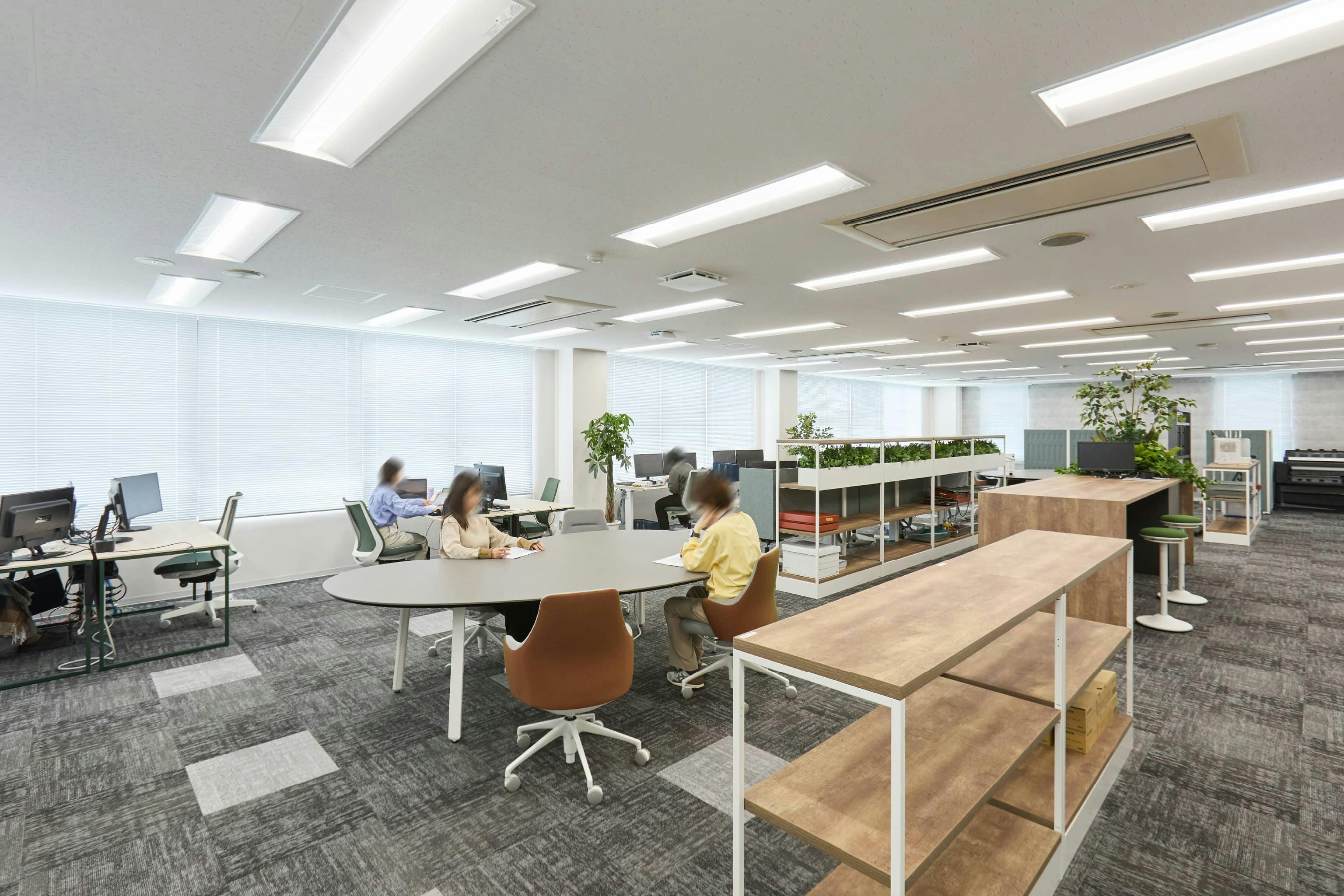 株式会社荒谷建設コンサルタント 様の事例写真／[4F執務スペース]フロアの中央部に、松江の神話に由来する「勾玉」の形を模したテーブルが配置されています。